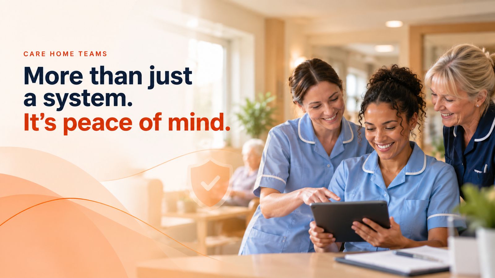 Three care home team members smiling as they look at a tablet together. Care home teams: more than just a system, it’s peace of mind.